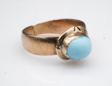 A Victorian 18 carat rose gold solitaire ring, set to centre with a pale blue glass cabochon in an