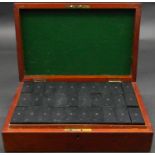 An antique mahogany boxed 90 piece bone, ebony and brass domino set. Each piece with painted