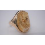 A carved citrine ring with a relief classical portrait set in a yellow metal setting with D-shape