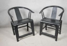 A pair of 19th century ebonised hooped back armchairs on shaped stretchered supports. H.87cm