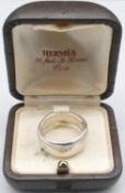 A vintage silver Hermes sculptural cross over design ring with vintage Hermes box. Signed Hermes,