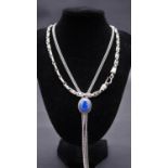 Two silver necklaces. One extra long silver curb link chain with Lapiz Lazuli set adjustable