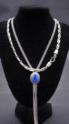 Two silver necklaces. One extra long silver curb link chain with Lapiz Lazuli set adjustable