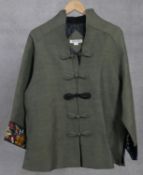 An oriental linen jacket with silk lining and embroidered panels to the arm. Decorated with