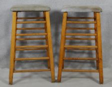 A pair of vintage teak framed vaulting horses or exercise stools with tops upholstered in suede. H.