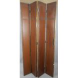 A tall four panel three fold screen with studded leather to one side and velour covering to the