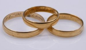 Three antique French yellow D-shape wedding bands (tests higher than 18 carat) Each inscribed with a