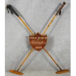 A vintage crossed Polo mallets match trophy from Hurlington, 1908. With wooden painted shield with