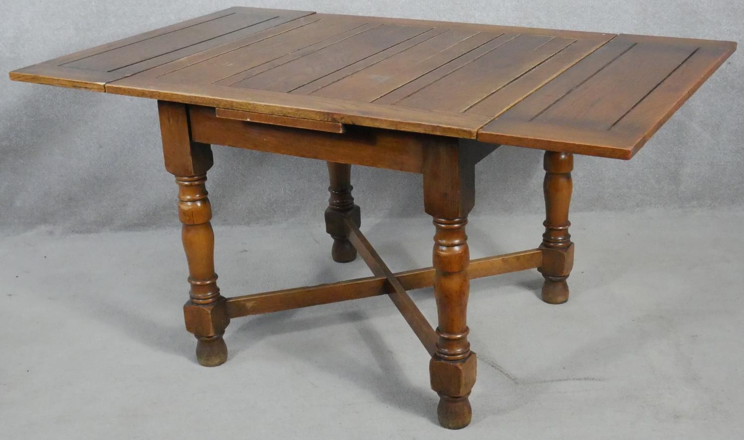 A mid century oak draw leaf table on turned stretchered supports. H.75 W.92 D.92cm - Image 3 of 4
