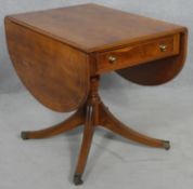 A Reprodux Regency style yew wood drop flap dining table on swept supports. H.74 W.60 D.85cm