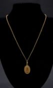 An 18 carat gold trace chain with a yellow metal (tests 18 carat) oval Our Lady of Miraculous
