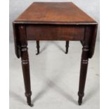 A 19th century mahogany drop flap Pembroke table with frieze drawer on turned tapering supports