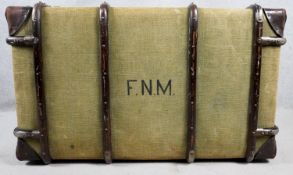 A C.1900 canvas travelling trunk bound with metal, leather and beech fitted with lift out tray. H.57