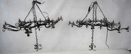 A pair of wrought iron ceiling hanging chandeliers each with nine candle sconces. H.105 W.110