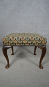 A mid century Georgian style mahogany stool in tapestry upholstery on cabriole supports. H.49 W.55