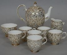 A Imperial bone china 24 carat gold plated floral design coffee set with, coffee pot, six cups,