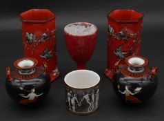 A pair of Arcadian ware red glaze hexagonal vases decorated with birds, along with a pair of Grecian