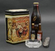 A collection of advertising items. Including a unopened limited edition Blak metal Coca Cola bottle,