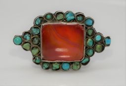 An Oriental silver white metal, Carnelian and Turquoise dress ring. Set to centre with a rectangular