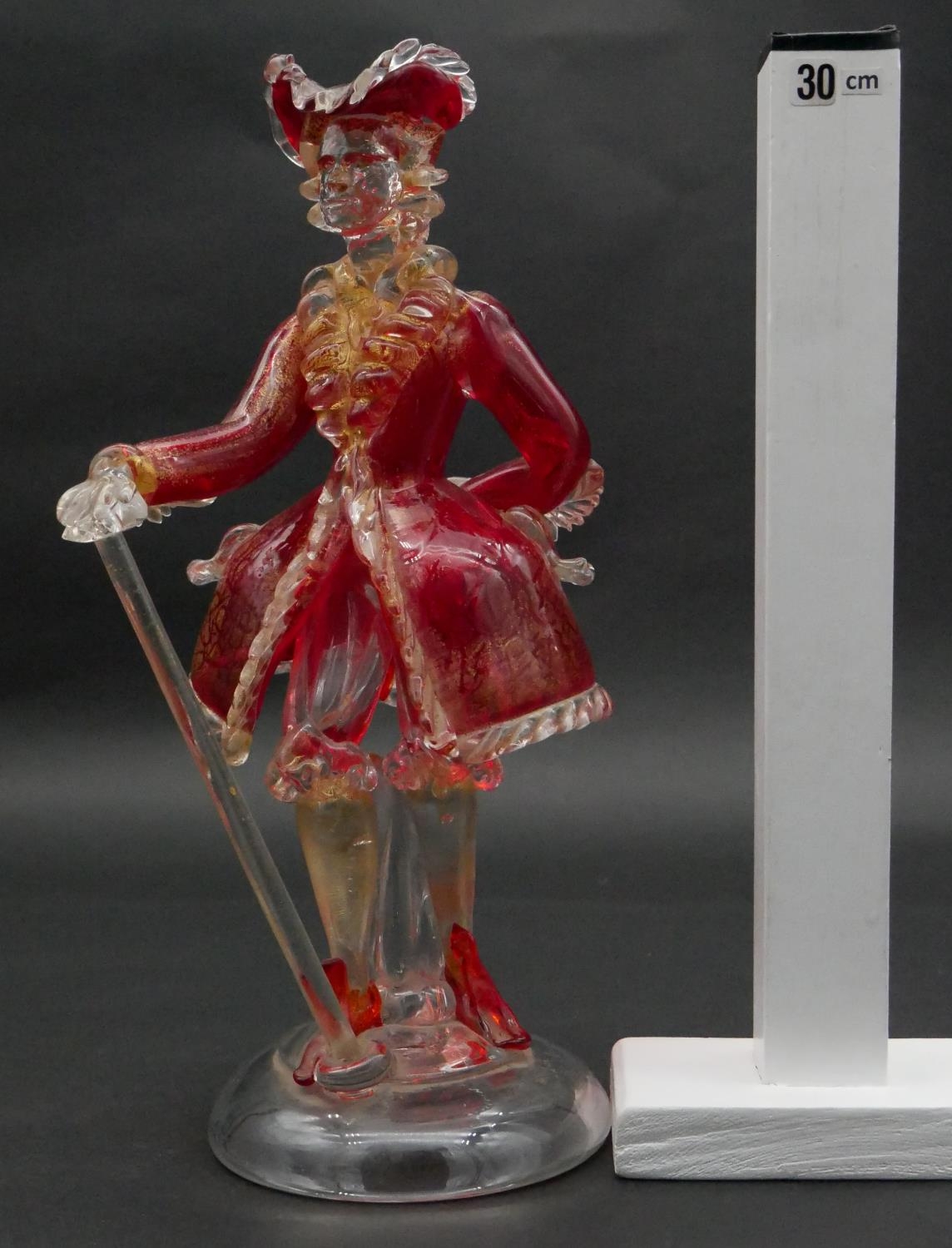 A vintage Murano gold flecked red glass figure of a Venetian gentleman with cane, on a clear round - Image 5 of 5