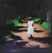 A framed and glazed C-print, titled "Alice", of a girl walking down a shady avenue. H.118 W.118cm