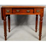 A late 19th century walnut single drop flap table fitted with three frieze drawers on turned