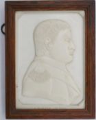 A framed 19th century carved ivory plaque of a relief profile of Napoleon, signed J. Kinder,