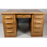 An early 20th century oak pedestal desk with maker's label. H.76 L.122 D.80cm