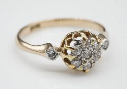 An antique old cut diamond and 18 carat yellow gold cluster ring. Set to centre with a round old cut