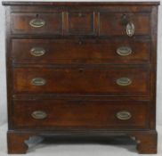 A Georgian country oak and mahogany crossbanded chest of drawers with ebony stringing on shaped