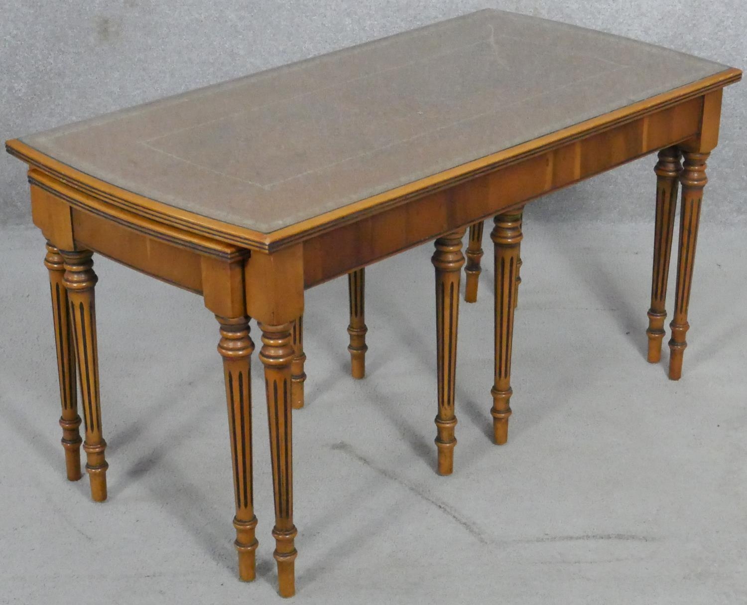 A nest of Regency style yew wood occasional tables with plate glass and inset tooled leather tops on - Image 3 of 6