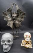 A Damien Hirst style skull, a metal skeleton head and torso and a figure of a mythological creature.