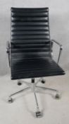 An Eames inspired desk chair in ribbed black leather upoholstery on chrome frame and base. H.110 W.