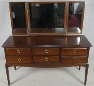 A vintage mahogany Stag furniture dressing table with triple adjustable mirrors. H.127 W.131 D.50cm