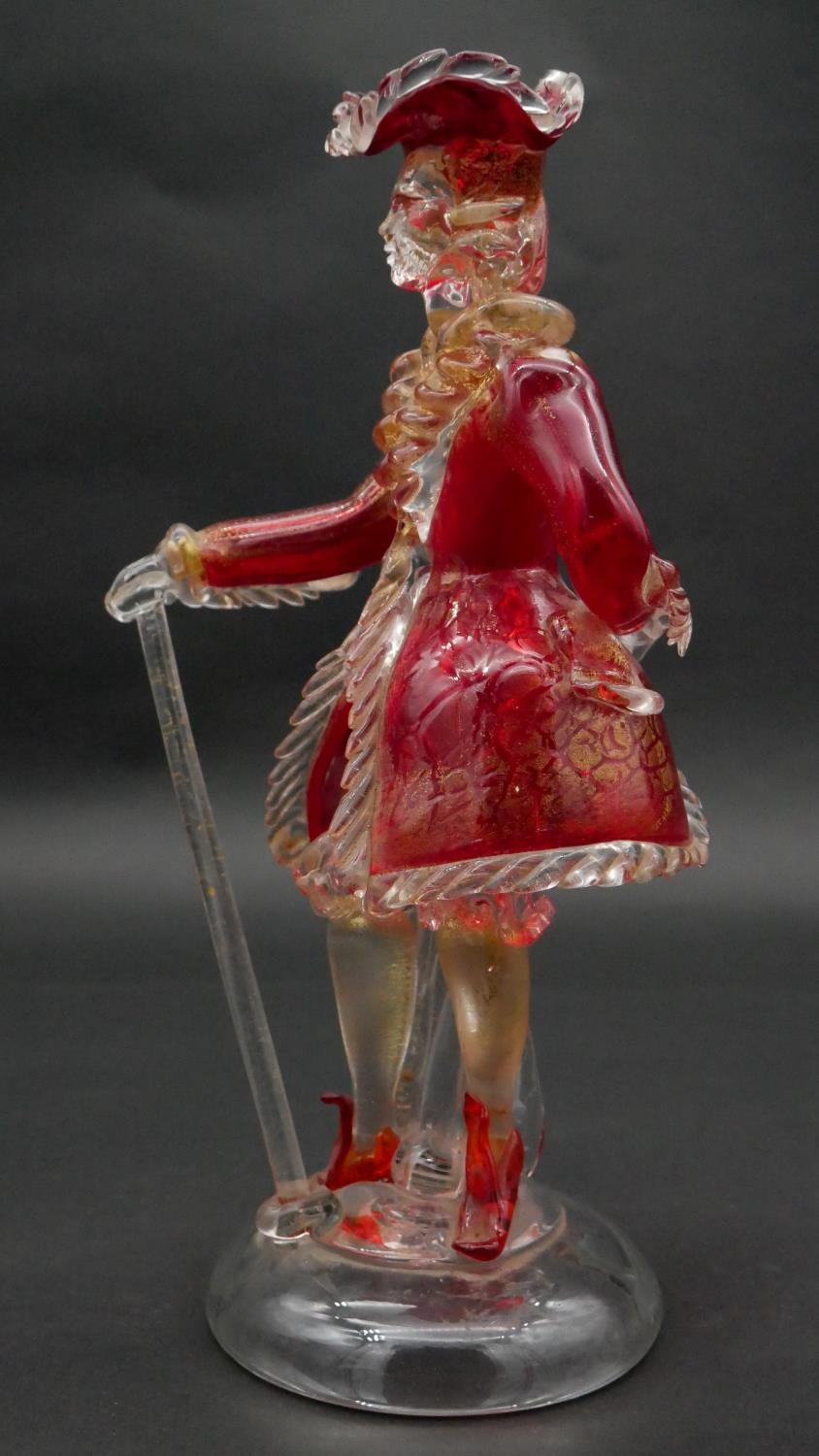 A vintage Murano gold flecked red glass figure of a Venetian gentleman with cane, on a clear round - Image 3 of 5