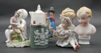 A small silver rimmed stoneware cup along with various ceramic figures and a pair of miniature