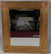 A wall mirror in reeded gilt frame. H.69 W.58cm