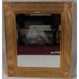 A wall mirror in reeded gilt frame. H.69 W.58cm