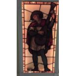 A painted carved frame antique French stained glass panel of a minstrel playing the lute. H.152 W.