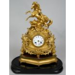 A 19th century French ormolu cased mantel clock with white enamel dial and eight day movement on