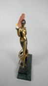 An Art Deco table lamp with glass fan shade and spelter dancer on stepped marble base. H.49 W.34