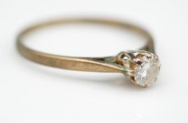 A vintage 9 carat yellow gold diamond solitaire ring. Set with a round brilliant diamond with an