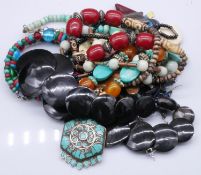 A collection of costume jewellery. Including turquoise and amber necklace, horn disc necklace and