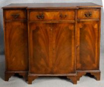 A Georgian style mahogany, crossbanded and satinwood strung breakfront credenza on bracket feet. H.
