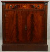 A Georgian style flame mahogany and crossbanded side cabinet with satinwood inlaid fan patera and