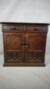A 19th century pitch pine Gothic style chiffonier with drawers and cupboards on plinth base. H.100