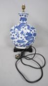 A Chinese blue and white dragon design porcelain moon vase table lamp, on lacquered base. H.48 W.33