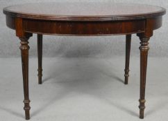 A 19th century style mahogany coffee table with tooled leather top and glass inset on turned