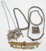 A collection of silver and white metal Tribal and Oriental jewellery including a white metal Russian