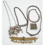 A collection of silver and white metal Tribal and Oriental jewellery including a white metal Russian